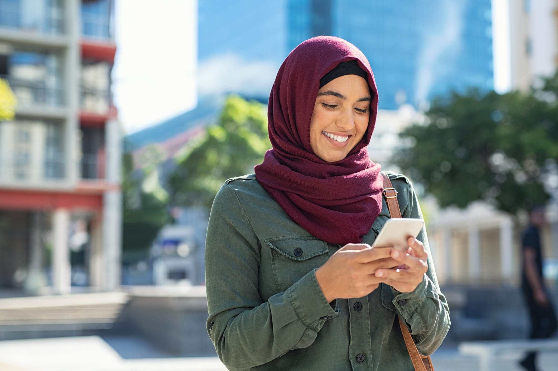 hijabi woman checking muslim pro app
